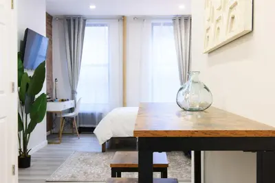 a room with a table with a vase on it at 240-9 Luxury Prime Location STUDIO W&D in New York