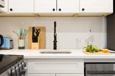 a kitchen counter with a sink and a cutting board at 240-9 Luxury Prime Location STUDIO W&D in New York