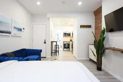 a bedroom with a bed and a living room at 240-9 Luxury Prime Location STUDIO W&D in New York