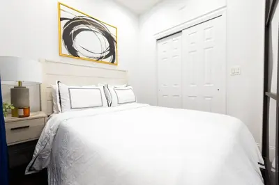 a white bedroom with a white bed and a window at 69-2D Stylish Lower East Side 1BR Apt BRAND NEW in New York