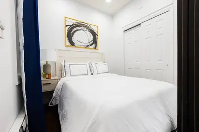 a white bedroom with a white bed and a window at 69-2D Stylish Lower East Side 1BR Apt BRAND NEW in New York