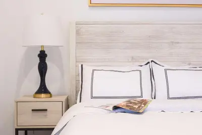 a bed with two pillows and a lamp on a night stand at 69-5A Modern Lower East Side 1BR Apt BRAND NEW in New York