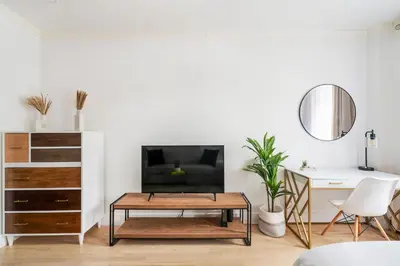 a living room with a coffee table and a tv at 1597-10 New Studio Upper East Side W&D in unit in New York