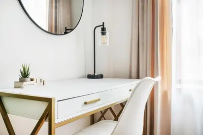 a desk with a mirror and a chair at 1597-10 New Studio Upper East Side W&D in unit in New York