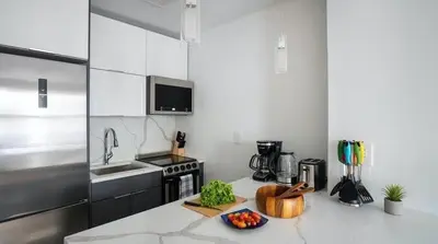 a kitchen with a counter with a bowl of fruit on it at 1597-11 Studio - Upper East Side Apt W&D in New York