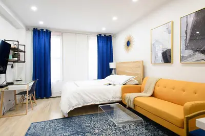 a living room with a couch and a bed at 1597-12 NEW Studio Prime UES WD in unit in New York
