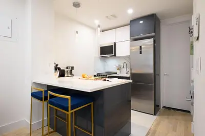 a kitchen with a counter and a refrigerator at 1597-12 NEW Studio Prime UES WD in unit in New York
