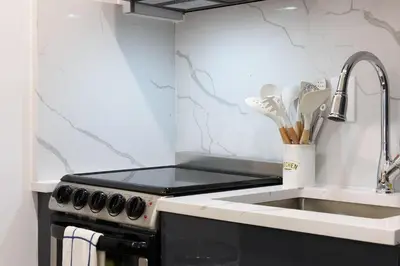a kitchen with a sink and a stove at 1597-12 NEW Studio Prime UES WD in unit in New York