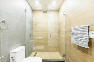 a bathroom with a glass shower with a toilet at 1597-13 I Brand new Studio Prime upper east W&D in New York