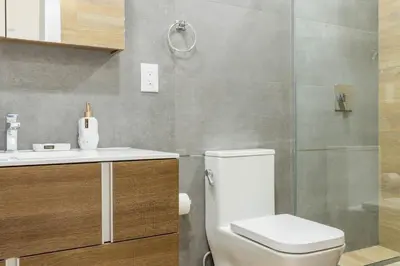 a bathroom with a toilet and a sink and a shower at 1597-13 I Brand new Studio Prime upper east W&D in New York