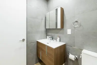a bathroom with a sink and a mirror and a toilet at 1597-13 I Brand new Studio Prime upper east W&D in New York