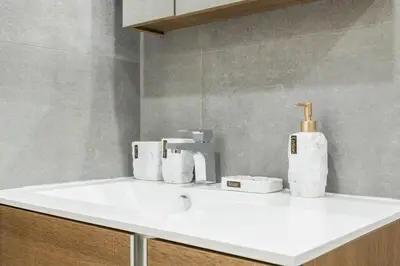 a bathroom sink with rolls of toilet paper on it at 1597-13 I Brand new Studio Prime upper east W&D in New York