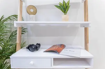 a white shelf with a book and headphones on it at 1597-13 I Brand new Studio Prime upper east W&D in New York