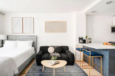 a living room with a bed and a couch and a table at 1597-14 New Renovated Studio rime UES - W D in New York