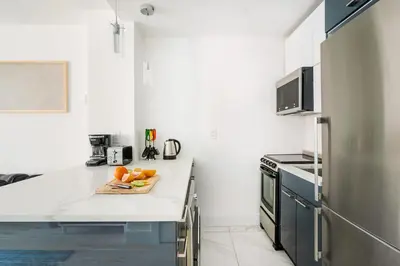 a kitchen with a counter with fruit on a cutting board at 1597-14 New Renovated Studio rime UES - W D in New York