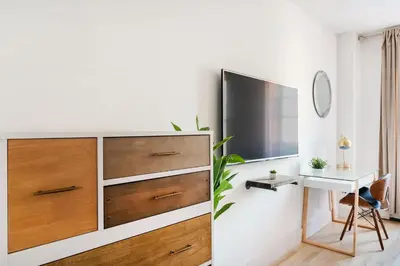 a bedroom with a chest of drawers and a desk at 1597-14 New Renovated Studio rime UES - W D in New York
