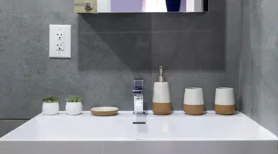 a bathroom counter with a sink with toiletries on it at 1597-14 New Renovated Studio rime UES - W D in New York
