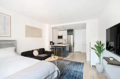 a white bedroom with a bed and a couch at 1597-14 New Renovated Studio rime UES - W D in New York