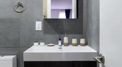 a bathroom with a white sink and a mirror at 1597-14 New Renovated Studio rime UES - W D in New York