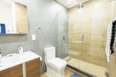 a bathroom with a shower and a toilet and a sink at 1597-1 Large studio W D in the unit prime UES in New York