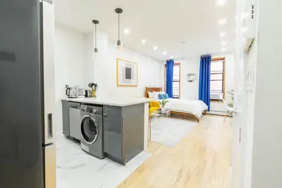 a kitchen with a washing machine in a room at 1597-1 Large studio W D in the unit prime UES in New York