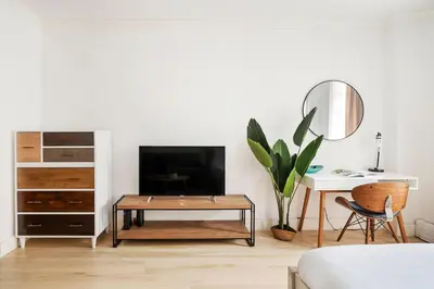 a living room with a tv and a table at 1597-2 Luxury Upper East Side Studio W&D in New York