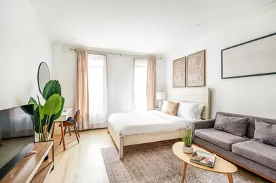 a living room with a bed and a couch at 1597-2 Luxury Upper East Side Studio W&D in New York