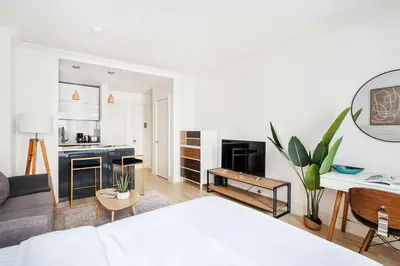 a living room with a bed and a kitchen at 1597-2 Luxury Upper East Side Studio W&D in New York