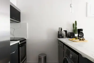 a kitchen with a stove and a counter top at 1597-3 Studio Upper East Side Apt W&D in unit in New York