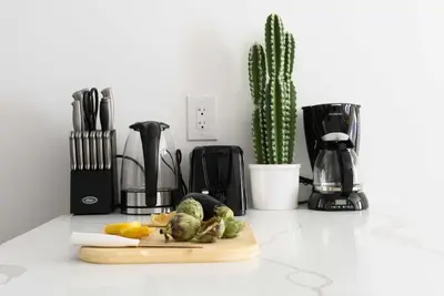 a kitchen counter with a cutting board with fruits and vegetables at 1597-3 Studio Upper East Side Apt W&D in unit in New York