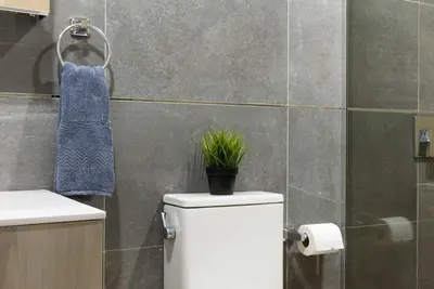 a bathroom with a toilet with a plant on it at 1597-3 Studio Upper East Side Apt W&D in unit in New York