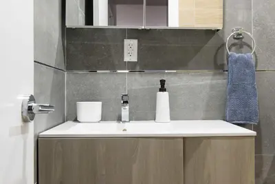 a bathroom with a sink and a blue towel at 1597-3 Studio Upper East Side Apt W&D in unit in New York