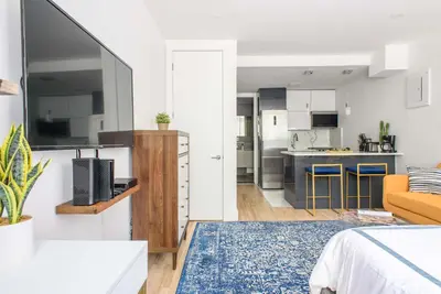 a living room with a bed and a kitchen at 1597-3 Studio Upper East Side Apt W&D in unit in New York
