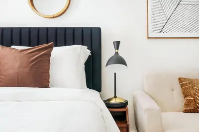 a bedroom with a bed and a lamp and a chair at 1597-4 Brand new Prime UES W D walk to C park in New York