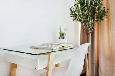 a table with a glass top and a white chair at 1597-4 Brand new Prime UES W D walk to C park in New York