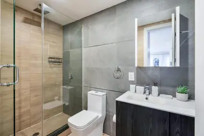 a bathroom with a toilet and a sink and a shower at 1597-4 Brand new Prime UES W D walk to C park in New York