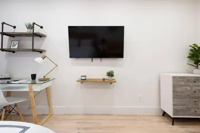 a living room with a tv on a white wall at 1597-5 New Studio Prime UES W D in unit in New York
