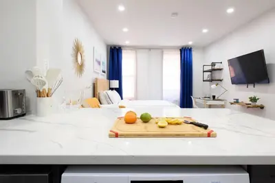 a kitchen counter with a cutting board with fruit on it at 1597-5 New Studio Prime UES W D in unit in New York