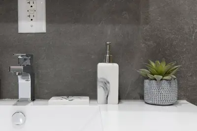 a bathroom with a white sink and a plant at 1597-5 New Studio Prime UES W D in unit in New York