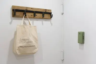a bag hanging on a wall next to a harmonica at 1597-5 New Studio Prime UES W D in unit in New York