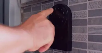 a person holding a black remote control on a wall at 1597-6 Luxury Studio Upper East Side W&D in New York