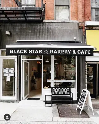 a black star bakery and cafe sign in front of a store at 1597-6 Luxury Studio Upper East Side W&D in New York
