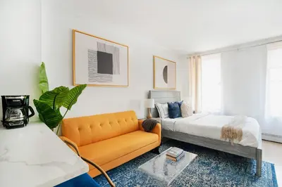 a living room with a couch and a bed at 1597-7 Luxury Upper East Studio W&D in unit in New York
