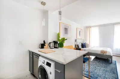 a kitchen with a washer and dryer in a room at 1597-7 Luxury Upper East Studio W&D in unit in New York