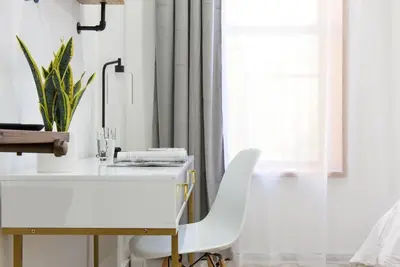 a white desk with a white chair next to a window at 1597-8 Luxury STUDIO Upper East Side W&D in New York