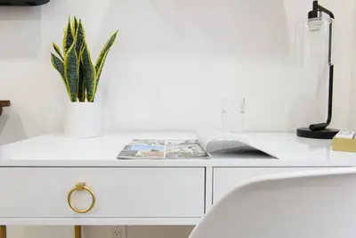a white desk with a potted plant on it at 1597-8 Luxury STUDIO Upper East Side W&D in New York