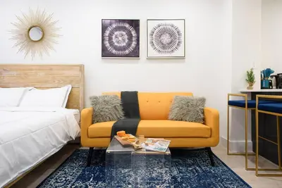 a living room with a couch and a bed at 1597-8 Luxury STUDIO Upper East Side W&D in New York