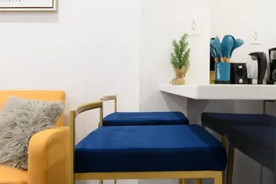 a room with two chairs and a table with a blue seat at 1597-8 Luxury STUDIO Upper East Side W&D in New York