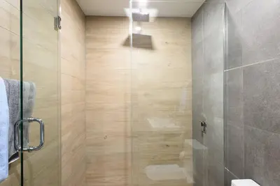 a bathroom with a shower with a glass door at 1597-8 Luxury STUDIO Upper East Side W&D in New York