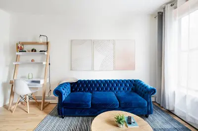 a blue couch in a living room with a table at 1597-PHN PH Duplex -Private Outdoor Deck W D in New York